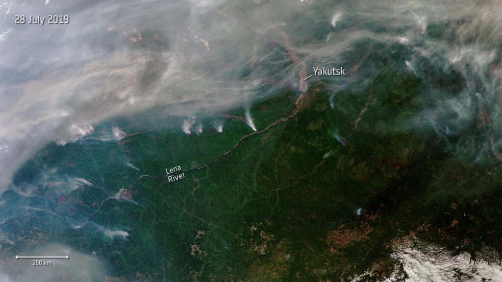 Satelite image dated 28 July 2019. Shows smoke and fire across a wooded landscape; the city of Yakutsk is in the upper right centre; the Lena River is indicated lower left centre and flows north-east to Yakutsk before bending northwards. The edges of the image are obsured by smoke rising from forest fires