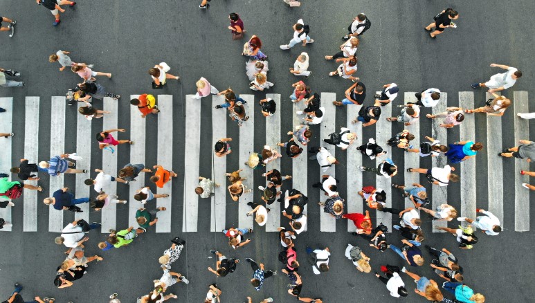 Aerial view of a pedestrian crossing. Numerous people are crossing in both directions